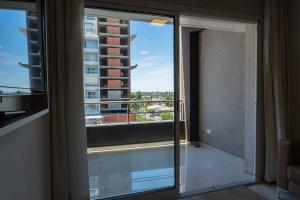 a room with a window with a view of a building at Live Inn Neuquen in Neuquén