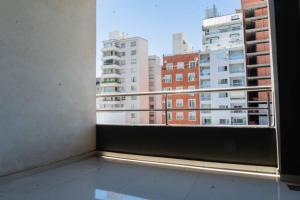 a balcony with a view of a city at Live Inn Neuquen in Neuquén