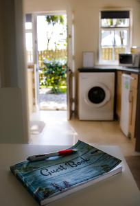 a book sitting on top of a table in a kitchen at Cottage at the Alms - Dog Friendly! in Strangford