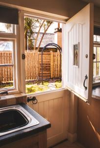 a kitchen with a sink and a window at Cottage at the Alms - Dog Friendly! in Strangford