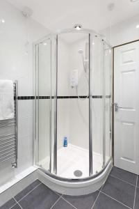 a shower with a glass enclosure in a bathroom at Emporium Apartments - Nottingham City Centre - Your own 7 Bedrooms Apartment with 3 Bathrooms and full Kitchen - "Cook as you would at Home" - opposite Victoria Centre Shopping Centre - Outdoor Parking for Cars or Vans at five pounds a day in Nottingham