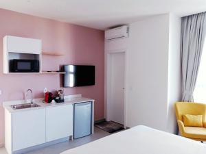 a small kitchen with a sink and a microwave at Waypoint Suites - Appartements meublés in Dakar