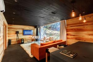 a living room with a couch and a table at Ort Hotel in Campos do Jordão