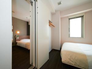 Postel nebo postele na pokoji v ubytování Super Hotel Shinjuku Kabukicho