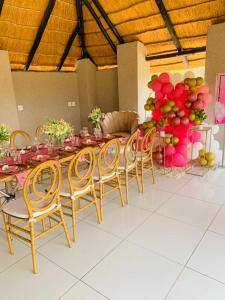 a dining room with a long table and chairs at Siyaya’s Guest Palace in Jozini