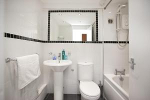 a white bathroom with a toilet and a sink at Victoria Centre Apartments in the Victoria Centre Shopping Centre - Nottingham City Centre - 24 hour access - Most Central Location, Kitchen - Sunday check-out 1pm - Opposite Hilton by Restaurants & Shops - Outdoor Parking Cars or Vans five pounds a day in Nottingham +118 photos