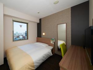 Postel nebo postele na pokoji v ubytování Super Hotel Shinjuku Kabukicho