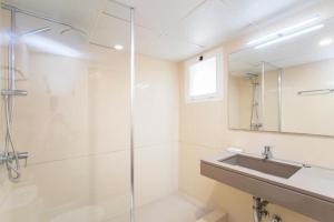 a bathroom with a shower and a sink and a mirror at Isabela 2a 3 habitaciones con ático in Port de Pollensa