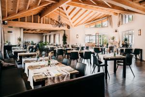 ein Restaurant mit Holzdecken, Tischen und Stühlen in der Unterkunft Hotel Birkenhof in Heidelberg