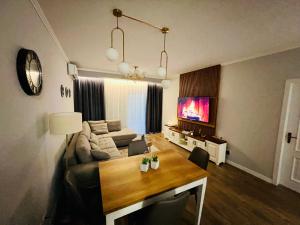 a living room with a couch and a table at Luxury Apartaments Tirana in Tirana