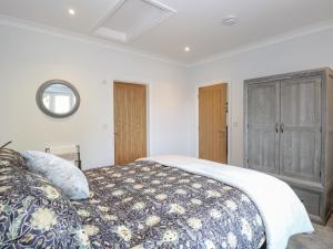 a bedroom with a large bed and a window at Robin's Nest in Brisley