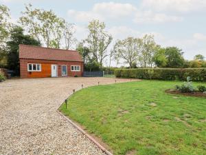 a house with a large yard in front of it at Robin's Nest in Brisley