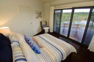 a bedroom with a bed with a view of a deck at Kooyar Mia in Metricup