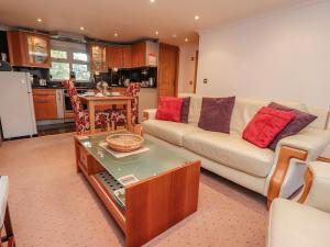 a living room with a couch and a table at Bronte Cottage in Keighley