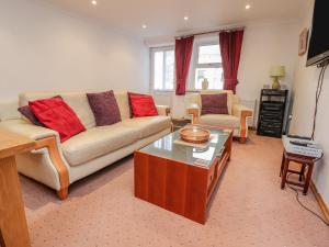 a living room with a couch and a coffee table at Bronte Cottage in Keighley
