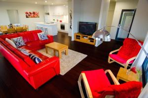 a living room with a red couch and red chairs at Kooyar Mia in Metricup