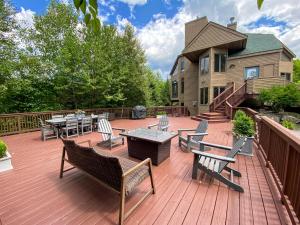 a deck with benches and tables on a house at CR1 Top Rated Ski-In Ski-Out Townhome Great views fireplaces fast wifi AC - Short walk to slopes in Carroll