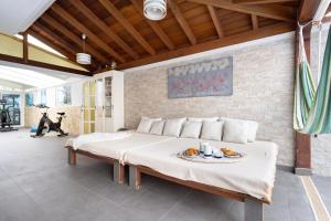 a bedroom with a large bed with a table on it at LUXURY VILLA WITH PRIVATE POOL WITH AIRCON,Playa del Duque in Adeje