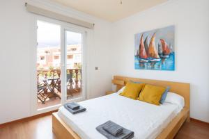 a bedroom with a bed and a large window at LUXURY VILLA WITH PRIVATE POOL WITH AIRCON,Playa del Duque in Adeje