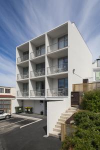 an apartment building with balconies and a parking lot at 315 Euro Motel and Serviced Apartments in Dunedin