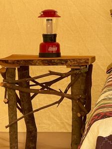 a table with a bottle of alcohol on top of it at Tentrr Signature Site - 6 Ponds Farm Glamping in Morganton