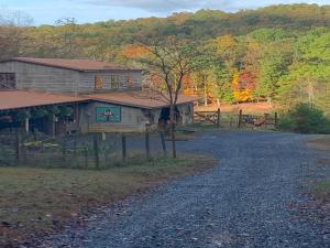 a house on the side of a gravel road at Tentrr Signature Site - 6 Ponds Farm Glamping in Morganton