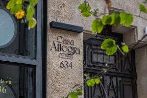 a sign on the side of a building at Hotel Casa Allegra Art Suites in Rosario