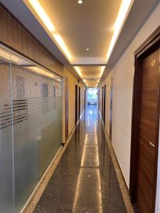 a corridor in a building with a hallway at Royal Indraprastha The Hotel in Bengaluru