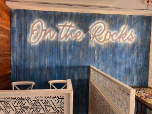 a sign that says on the rocks on a wall at Royal Indraprastha The Hotel in Bengaluru