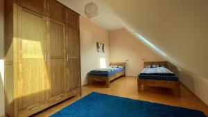 Pokój na poddaszu z 2 łóżkami i schodami w obiekcie Alpakahof Gaias Garten w mieście Kriebstein