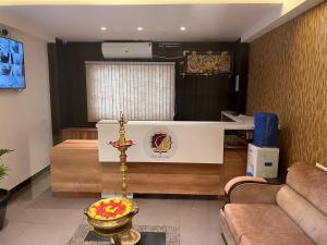 a living room with a desk and a couch at Royal Indraprastha The Hotel in Bengaluru