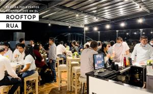 a crowd of people sitting at tables in a restaurant at Rua Hoteles Piura in Piura