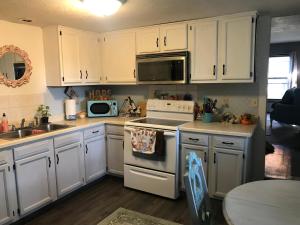 a kitchen with white cabinets and a stove top oven at Hope Bed and Breakfast in Canton