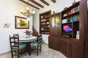 a dining room with a table and a tv at Vivalidays Rosa - Blanes in Blanes
