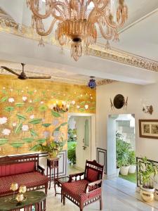 a living room with a large painting on the wall at Jagat Niwas Palace in Udaipur