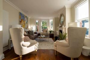 a living room with two chairs and a couch at The Bend in Bransgore