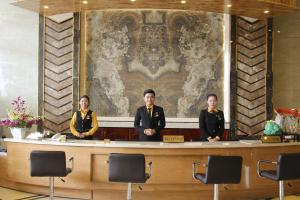 a group of three people standing behind a counter at West Hotel in Can Tho +16 photos