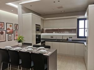 a kitchen with a table and chairs in a kitchen at wafms Apartments in Riyadh