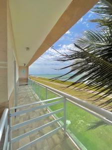 a staircase with a view of the beach from a house at Suítes Brandi in Arraial do Cabo