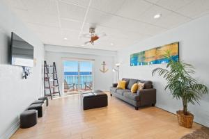 a living room with a couch and a view of the ocean at Sans Souci 407 in Pensacola Beach