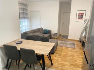 a living room with a table and a couch at Apartment Diana Zara parking free in Zadar