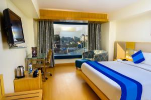 Postel nebo postele na pokoji v ubytování Keyon By Kumar + 25 fotografií