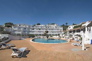 a resort with a swimming pool and white buildings at 413 Casa Marsalema in Salema