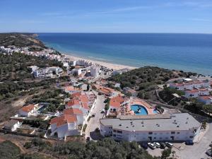 an aerial view of a resort and the ocean at 413 Casa Marsalema in Salema