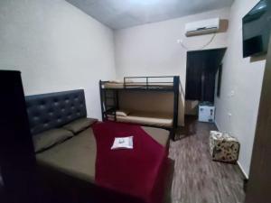 a room with a bed and a table at Hostel Aeroporto in Guarulhos
