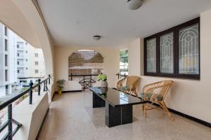 a living room with a table and chairs at Corner Stay Serviced Apartment-Racecourse in Coimbatore