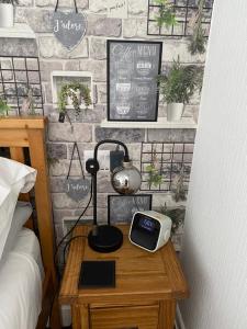 a bedroom with a table with a clock on it at Willow Dene in Scarborough