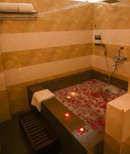 ein Badezimmer mit Badewanne und Kerzen auf dem Boden in der Unterkunft Rawai Luxury Tents Pushkar in Pushkar