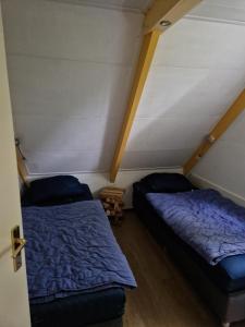 a room with two beds in a attic at Huuske 086 in Simpelveld