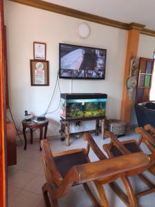 a living room with a fish tank and a tv at Hotel Boutique Los Gentiles in Santa Fe de Antioquia